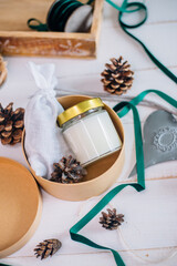 Gift in a box for Christmas candle with wooden wick in glass and fragrant sachet