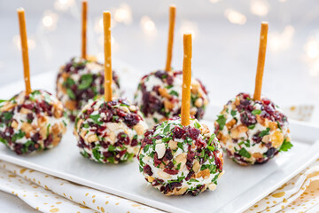 Christmas cheese ball appetizers with cranberries, pecans and herbs.