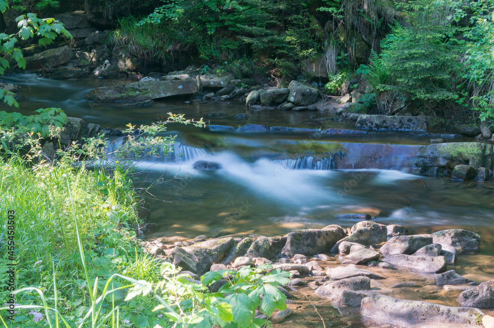 Poster Summer view on rocky creek Czarna Wiselka with long exposure in the polish mountains.