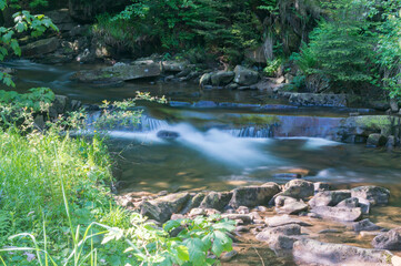 Naklejka na ściany i meble Summer view on rocky creek Czarna Wiselka with long exposure in the polish mountains.