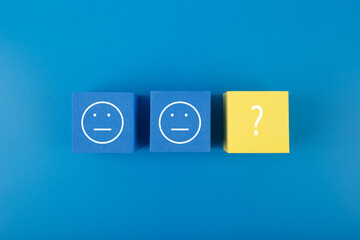 Blue and yellow cubes with emoji as metaphor for searching treatment and solution for mental or psychological problems. Minimal modern mental health concept in blue colors
