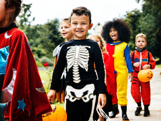 Young kids trick or treating during Halloween - Powered by Adobe