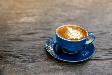 happy new year 2022 with late art on blue coffee cup on wooden table