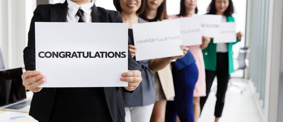 Businesspeople group in business clothes set row and holding paper banner with word congratulations...