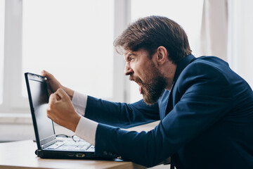 businessmen sitting at a desk in front of a laptop finance network technologies