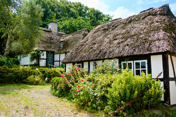 Naklejka na ściany i meble Beautiful Schlei region in Germany, Schleswig Holstein. German landscape in summer. Schlei river and typical houses with thatching, water reed roofs. Sieseby village