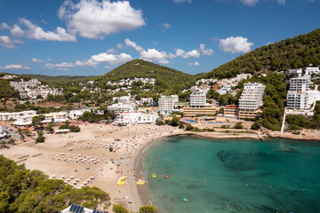 Aerial photo of the Spanish island of Ibiza showing the beautiful beach front and hotels and people...