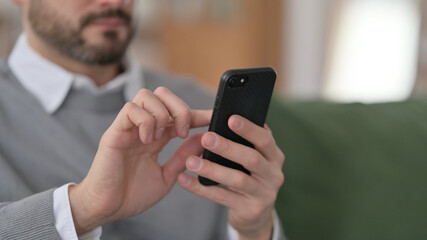 Close up of Hands of Middle Aged Man using Smartphone