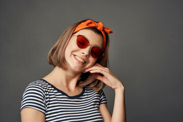 woman in sunglasses with an orange bandage on her head in a striped t-shirt fashion