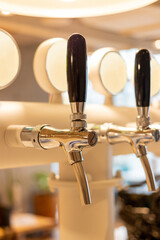 Fototapeta na wymiar Beer dispenser in stainless steel in bar 