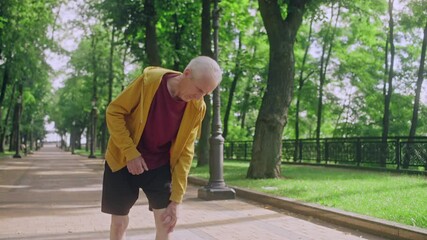 Mature man feeling knee pain while running in park, inflammation, injury