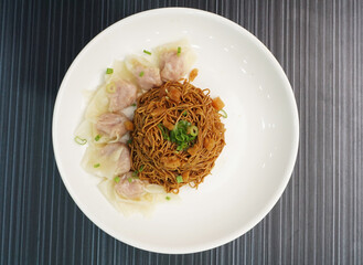 stir fried dry wanton noodle mee with meat dumpling on dark grey wood background dim sum halal menu