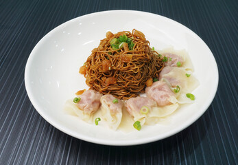 stir fried dry wanton noodle mee with meat dumpling on dark grey wood background dim sum halal menu