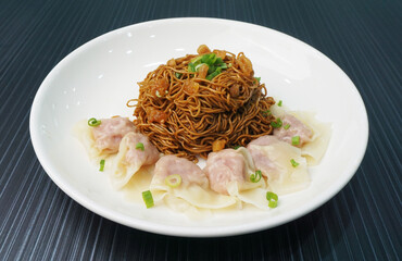 stir fried dry wanton noodle mee with meat dumpling on dark grey wood background dim sum halal menu