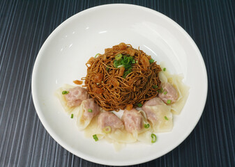 stir fried dry wanton noodle mee with meat dumpling on dark grey wood background dim sum halal menu