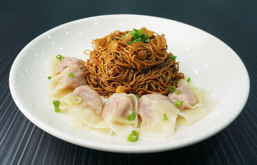 stir fried dry wanton noodle mee with meat dumpling on dark grey wood background dim sum halal menu