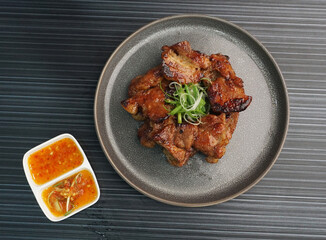 bbq grilled tender pork chop meat with sauce on dark grey wood background dim sum halal menu