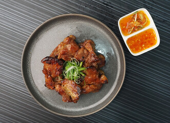 bbq grilled tender pork chop meat with sauce on dark grey wood background dim sum halal menu