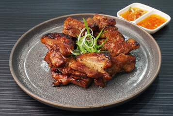 bbq grilled tender pork chop meat with sauce on dark grey wood background dim sum halal menu