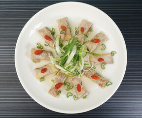 steamed chinese herbal chicken wrapped meat shape on dark grey wood background dim sum halal menu