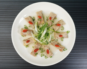 steamed chinese herbal chicken wrapped meat shape on dark grey wood background dim sum halal menu