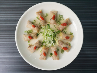steamed chinese herbal chicken wrapped meat shape on dark grey wood background dim sum halal menu