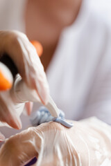 Facial blue gel mask on the brush. Prepearing for cosmetological peeling procedure.