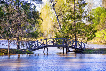 The State Historical, Artistic and Literary Museum - Reserve "Abramtsevo". A beautiful wooden bridge over the spring full-flowing Vorya river. Abramtsevo, Moscow Region, Russia, May 2021