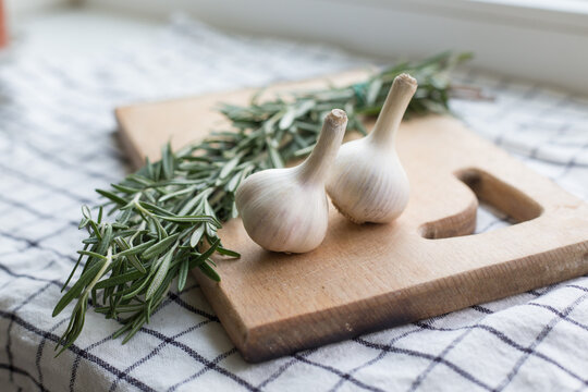 Rosemary and garlic on the wooden board