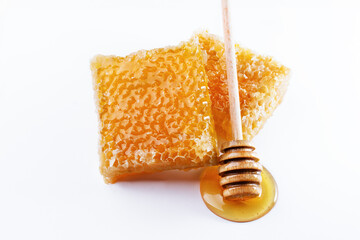 Sweet honey and honeycomb. Healthy organic honey, slices of honeycomb and wooden honey dipper...