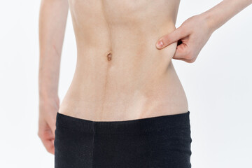 Fototapeta na wymiar woman pulls in belly strip waist diet health slimming