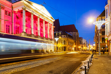 tram in a motion blur at night city center and view on theater, Wroclaw, Poland