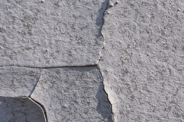 Old wall-  destroyed plaster. Grainy background- cracks, chips, peeling paint