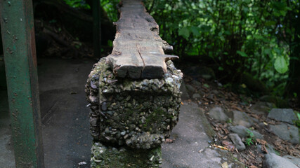 Fototapeta na wymiar Homemade wooden step on a stone