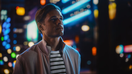 Handsome Blonde Man Standing on a Street of a Night City. Thoughtful Attractive Young Man...