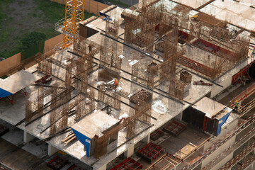 Top view of the construction of a skyscraper in the rays of sunlight on a summer morning