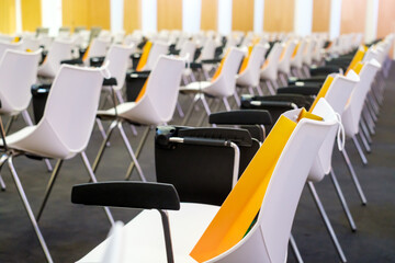 Chairs with bags in modern conference hall