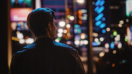 Handsome Man Walking Through Night City. Attractive Young Man Traveling, Looking Around Urban Center Contemplating Business Ideas, Future Career.
