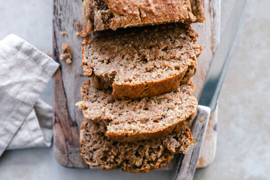 Sliced banana bread on a wooden chopping board