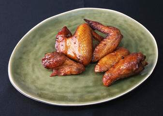 local charcoal bbq grilled honey golden chicken wing in plate on dark grey wood table asian dim sum...