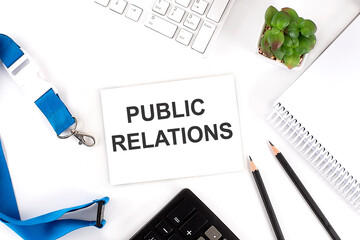 PUBLIC RELATIONS Words on the card with keyboard and office tools