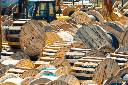 Minsk, Belarus. May 2019. Cable drums, wooden coils of electric cable. Storage of high voltage cable. Wooden spools with cable at warehouse. Electrical power cables at warehouse