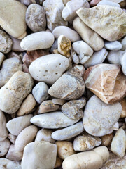 Ionian sea pebble marble stone beach close-up texture. Various rocky surface in Greece, Lefkada island coast
