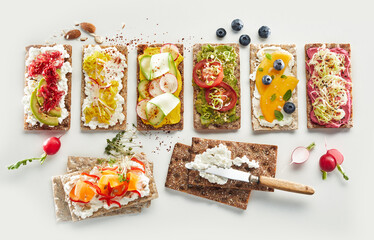 Crispbread toasts with fruits and vegetables on table