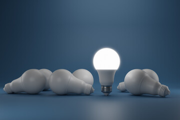 Glowing LED light bulb among non-luminous bulbs on a dark blue background. The concept of energy saving, creativity, individuality, ecology, innovation, ideas. 3D rendering.