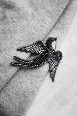 Seed bead embroidered brooch in a shape of black swallow bird