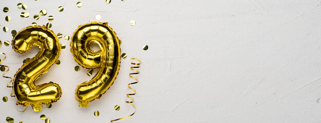 golden foil balloon number twenty nine. Birthday or anniversary card with the inscription 29. gray...