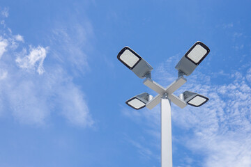 Solar light poles installed outside the building on a bright day sky background.