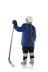 Full-length back view vertical portrait of young female hockey player in blue uniform, with stick...