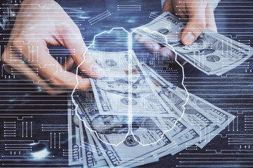 Multi exposure of brain drawing hologram and us dollars bills and man hands. Ai invest concept